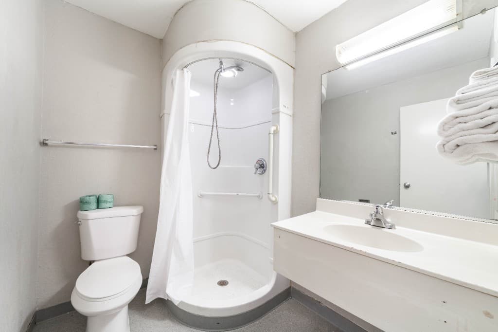 Guest bathroom with shower, vanity, and fresh towels